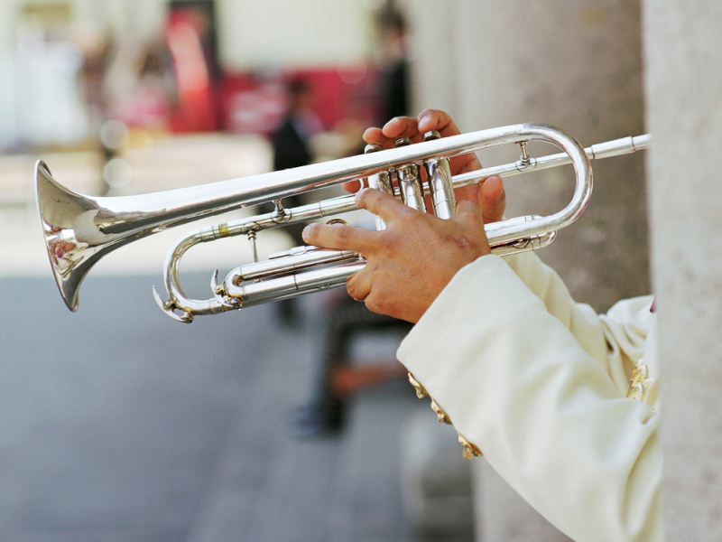 Side shot of a man playing the trumpet