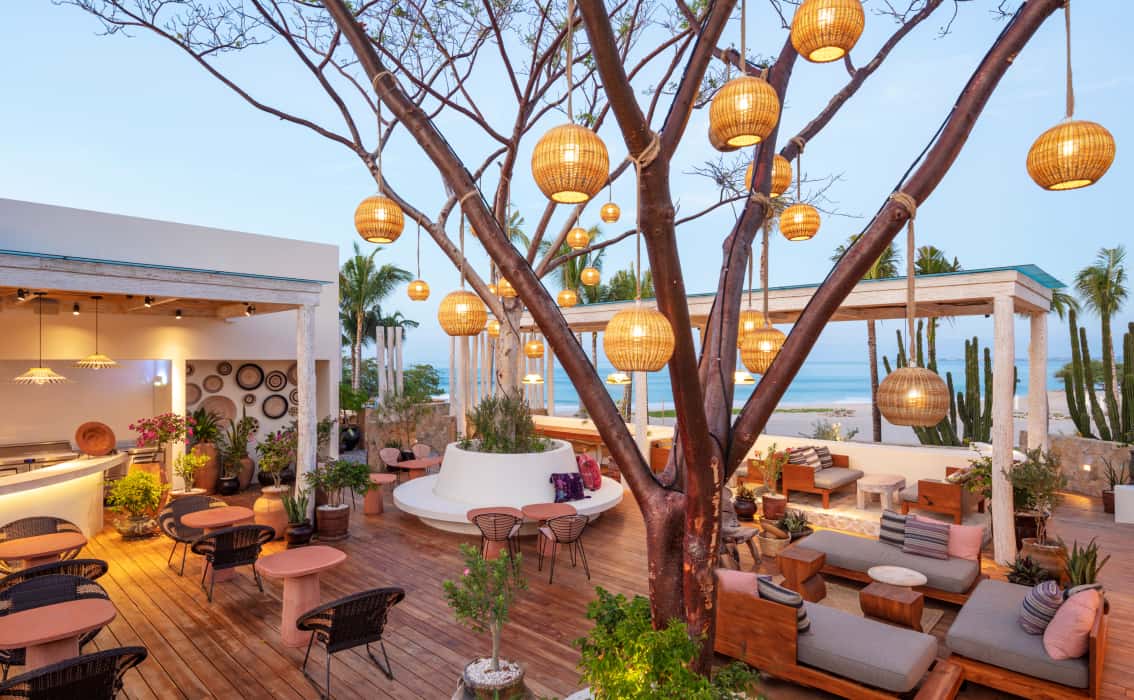 Outdoor restaurant seating highlighted by paper lanterns
